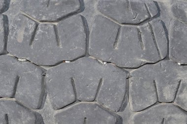 Worn-out old car tire,protector with stuck pebbles