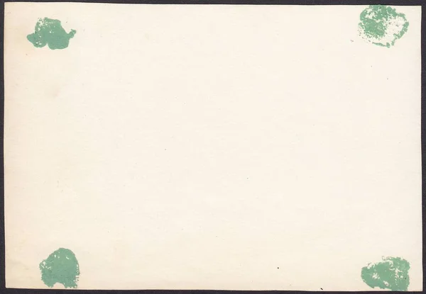 The reverse side of old photographs with traces of glue. stains from green paper, background