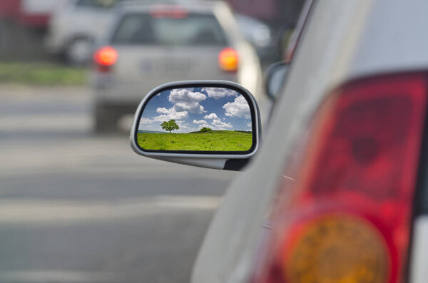 Looking in the side rear-view mirror during the traffic jam