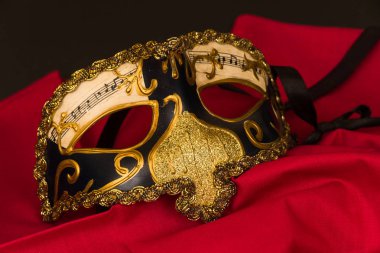 Venedik maske siyah arka plan ve boşaltmak kırmızı malzeme üzerinde.
