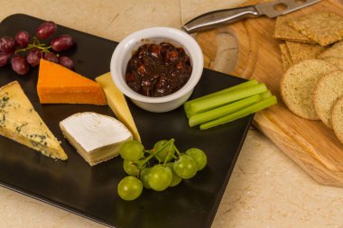 Peygamberli, tabağı, peynir, kırmızı Leicester, stilton, çedar, camembert, üzüm, kereviz, turşu veya Hint turşusu ve bisküvi.