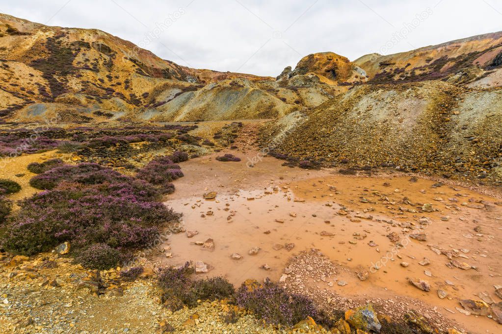Different coloured rocks in ex copper mine area. Parys Mountain, Amlwch, Anglesey, Wales, United Kingdom.