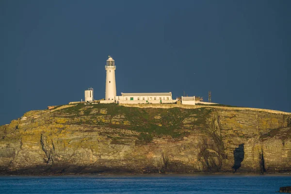 Lighthouse on rocky outcrop in morning light, telephoto view — Stock Photo, Image