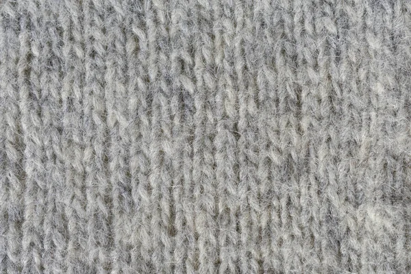 Close-up van gebreide grijze wollen textuur. — Stockfoto