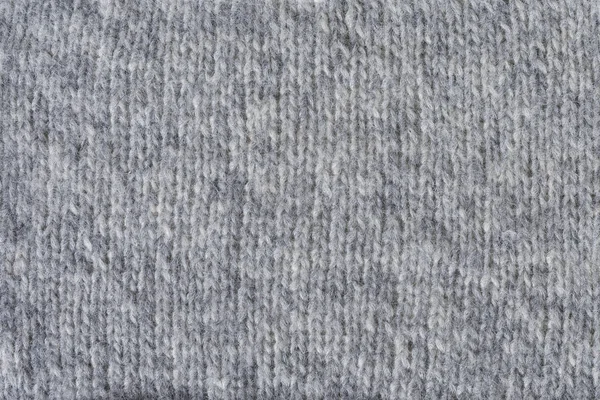 Gebreide grijze achtergrond. De textuur van de gebreide stof. — Stockfoto
