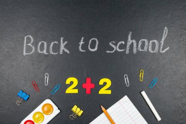 Renkli sayılar, sayma çubukları, tahtadaki matematik işaretleri. Okula dönelim. Kavramları. Tahtadaki okul malzemeleri. Yukarıdan görüntüle.