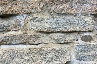 Arka plan veya doku için eski bir taş duvarın bir parçası.