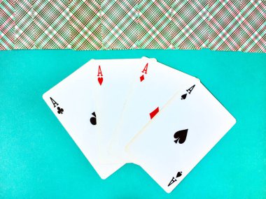 Mavi bir arka plan karşı farklı takım elbise eski oyun kartları dört as kazanan bir poker eli. Üst sıra ters kapalı oyun kartları. Üst görünüm, yakın çekim.