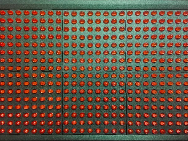 LED module on a white background. Red pixels on the LED module. Components for light advertising. Close-up.