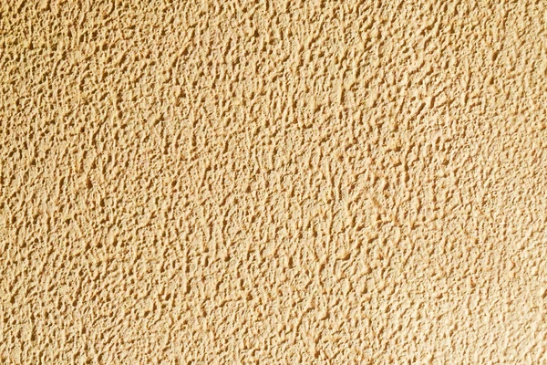 Part of the wall is beige with an interesting texture. Background and texture.