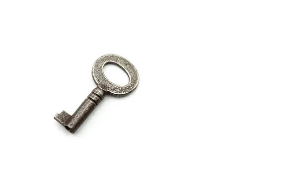 Old rusty antique key on white background