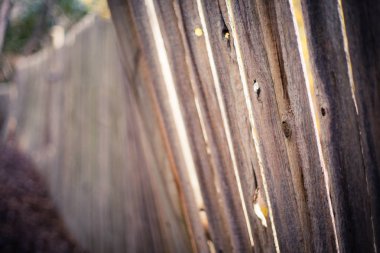 Light shining through old crooked fence clipart