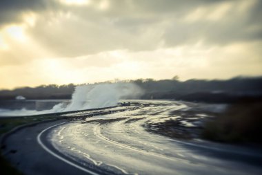 Newport, Ri 'de fırtına sırasında karayolu kenarında dalgalar çarpışıyor.