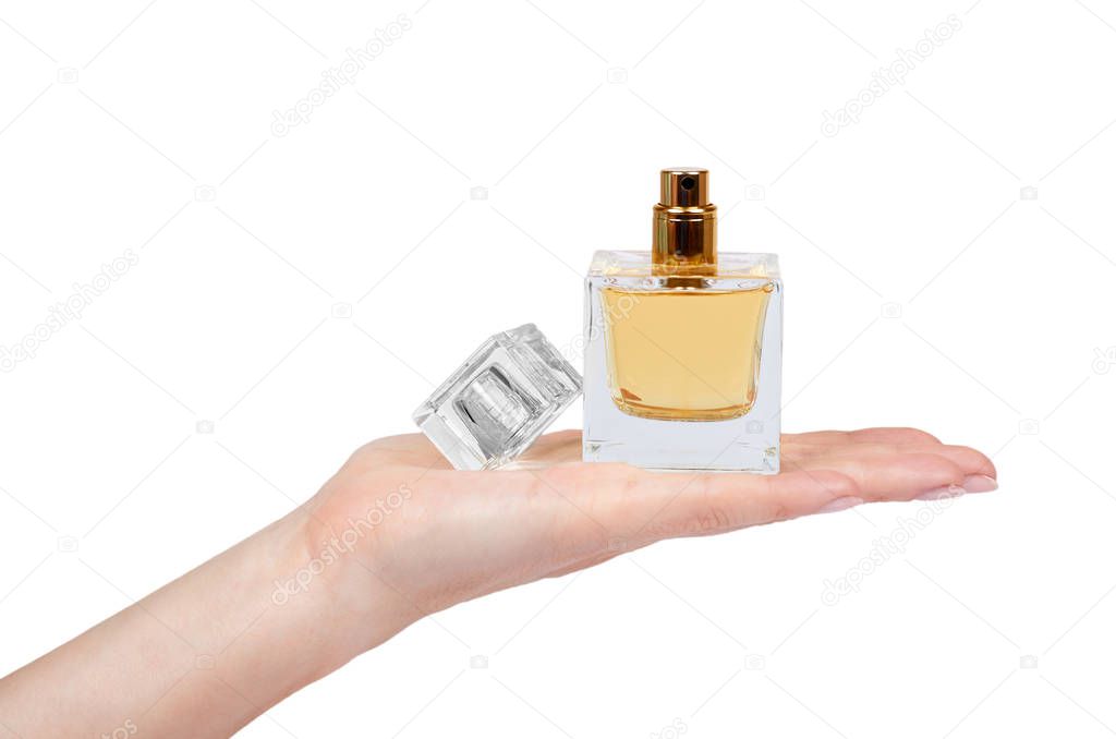 Golden perfume bottle with hand isolated on white background.