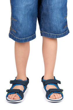 Kids leather sandals on leg isolated on a white background. clipart