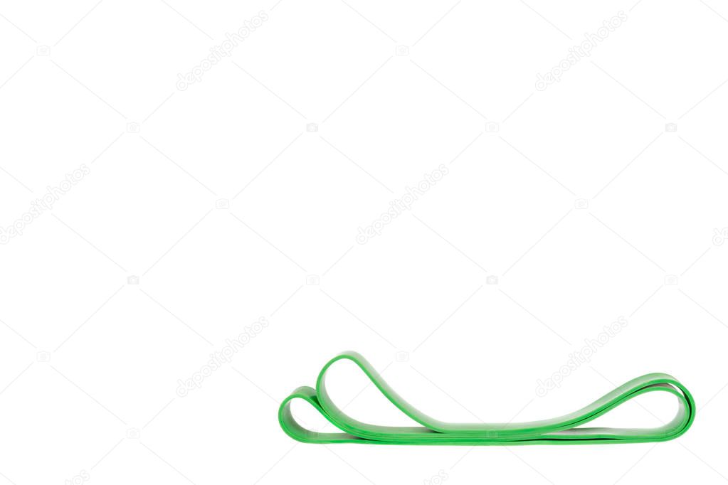 Green resistance band for fitness sport, isolated on white background, copy space template.