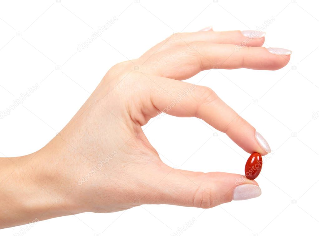 red vitamin capsule in blister with hand, medicine supplement. Isolated on white background