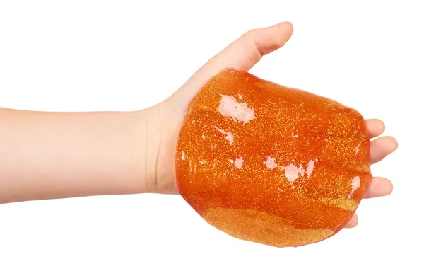 Kid playing orange slime with hand, transparent toy — Stock Photo, Image