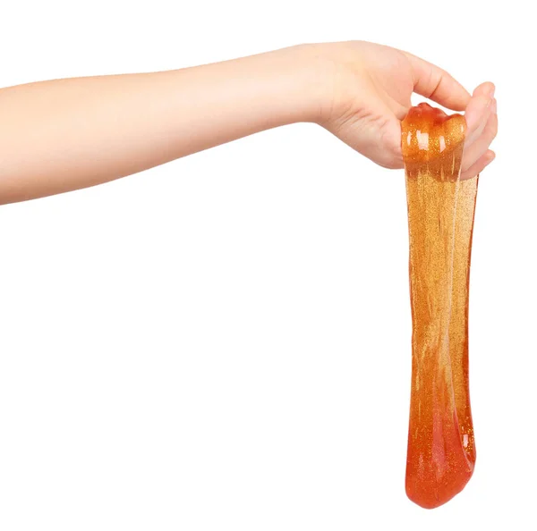 Kid playing orange slime with hand, transparent toy — Stock Photo, Image