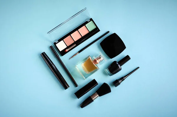 Different makeup products composition on blue background