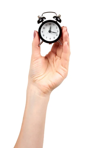 黒いレトロな目覚まし時計、鐘付きの古典的な時計と手. — ストック写真