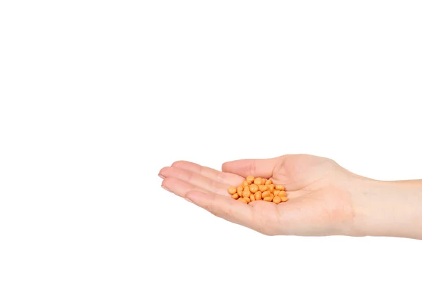 Hand met oranje pillen, medische zorg en hulp, chemische vitaminen. — Stockfoto