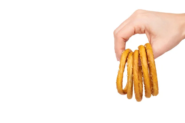 Hand with dried bagel, fresh baked bun, fast food snack. — Stock Photo, Image