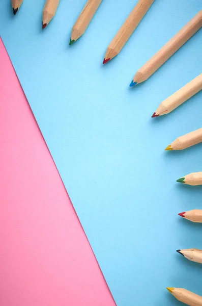 Wooden color pencils on blue background, flat lay — Stock Photo, Image