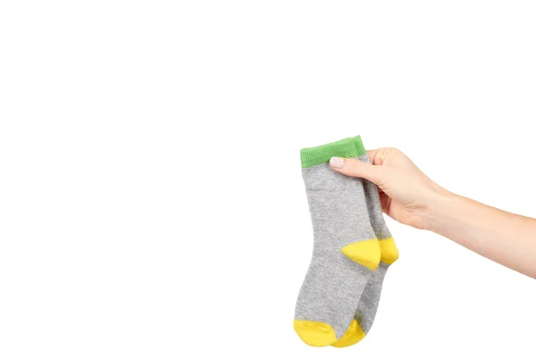 Hand with warm winter childrens socks, cute cotton clothes — Stock Photo, Image