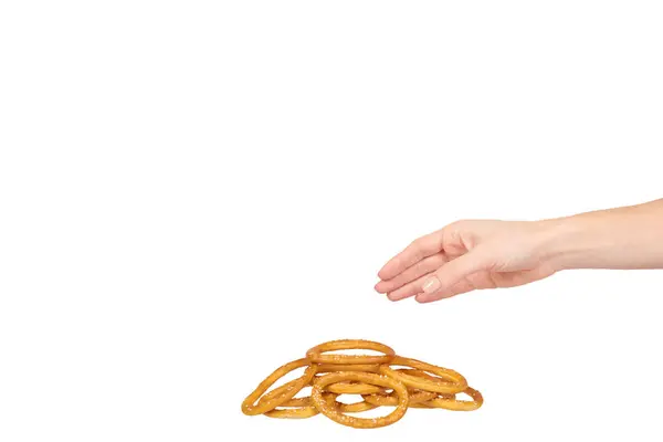 Hand with dried bagel, fresh baked bun, fast food snack. — Stock Photo, Image