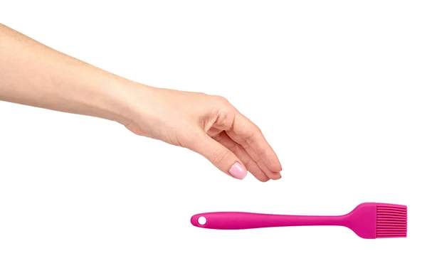 Hand with pink culinary brush, kitchen utensil. — Stock Photo, Image