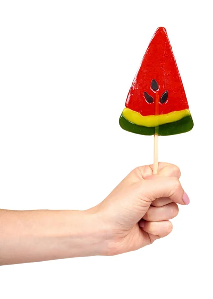 Hand with color lollipop, bright cool candy, watermelon shape. — Stock Photo, Image