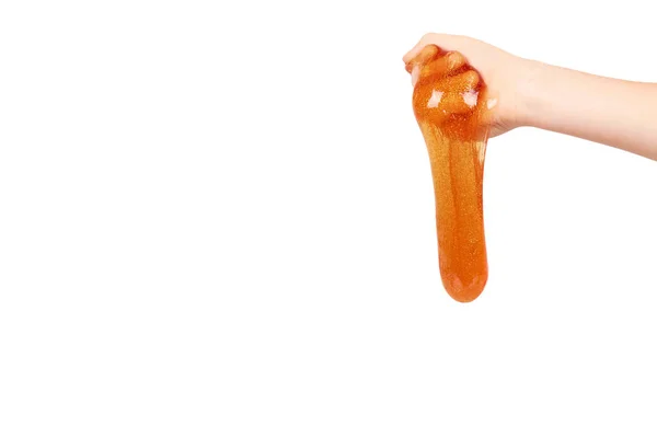 손으로, 투명 한 장난감 오렌지 점액을 재생 하는 아이 — 스톡 사진