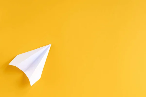 White paper plane on yellow background composition. — Stock Photo, Image