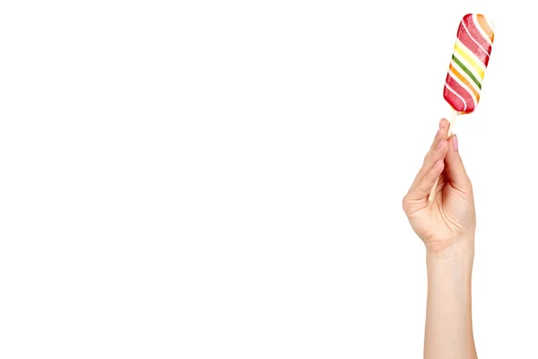 Hand with striped color lollipop, bright cool candy. — Stock Photo, Image