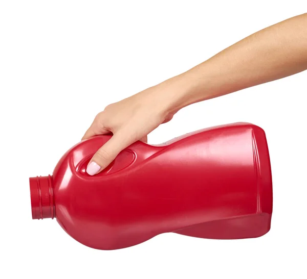 Ręka z czerwoną butelką detergentu, mydło do mycia w płynie do tekstyliów. — Zdjęcie stockowe