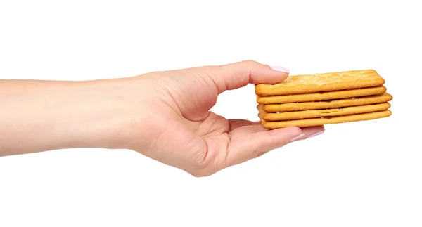 Hand met zoute cracker, knapperige voorgerecht, rechthoek vorm cookie. Geïsoleerd — Stockfoto