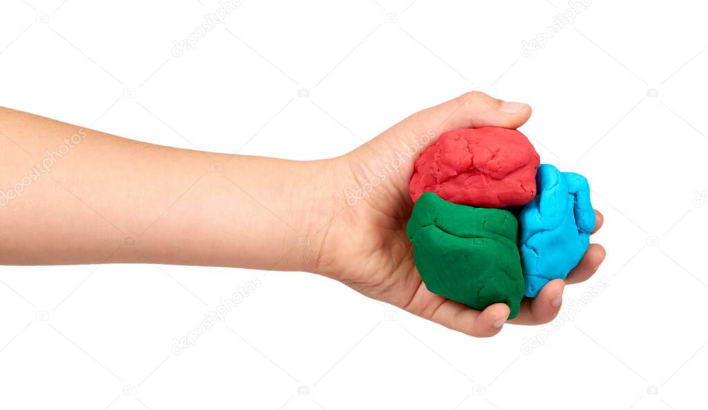 Children hand with color plasticine, kids educational toy.