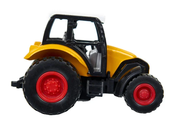 Juguete traktor de plástico amarillo. Vehículo agrícola, equipo de cosecha . — Foto de Stock