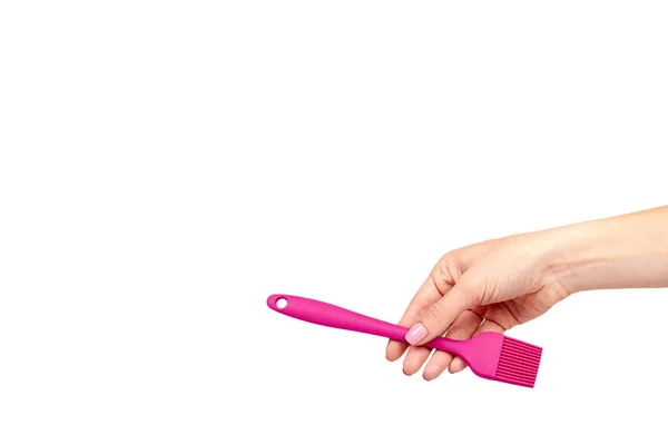 Hand with pink culinary brush, kitchen utensil. — Stock Photo, Image