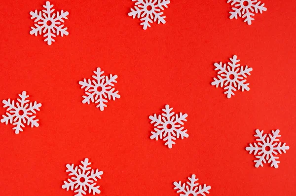 Composición de copos de nieve blancos sobre fondo rojo, Año Nuevo y vacaciones de Navidad . — Foto de Stock