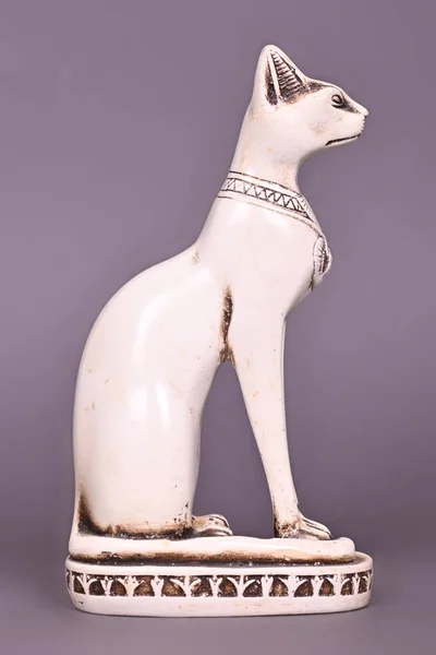 The Egyptian God in the form of a cat, a statuette of an animal on a gray background. High quality photo