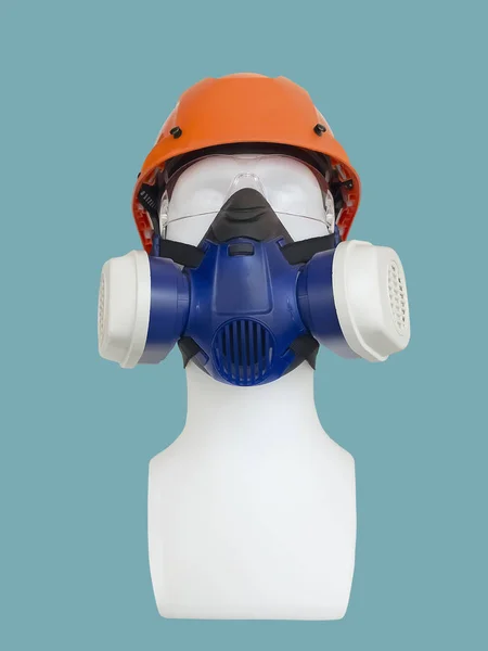Dust mask with valve and safety helmet on mannequin, isolated.