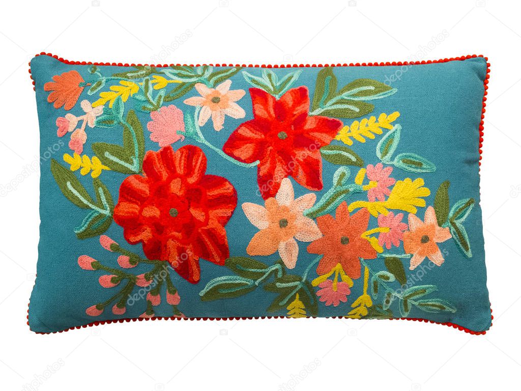 Colorful decorative pillow with a pattern of embroidered flowers, isolated on white background.