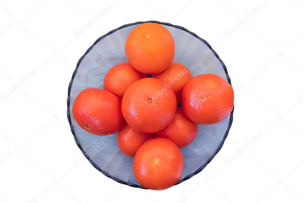 Ripe mandarins in blue glass bowl isolated on white background.  Top view.