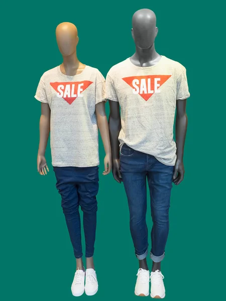 Two mannequins, male and female, wearing t-shirts on which \