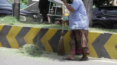 Cleaning the Streets with Care - An Elderly Hero Sweeps the Way