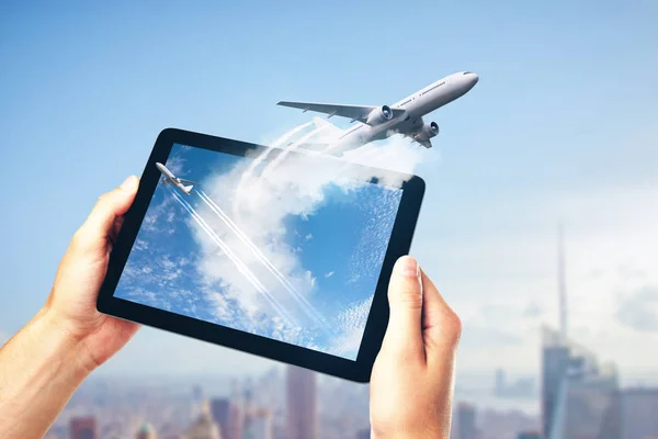 take off planes from digital tablet monitor in human hands at city background