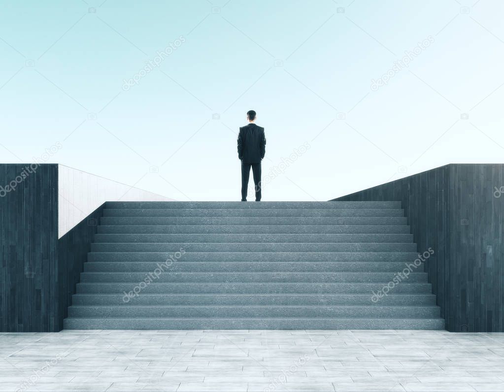 Businessman looking into the distance on abstract stairs. Sky background. Research and employment concept 