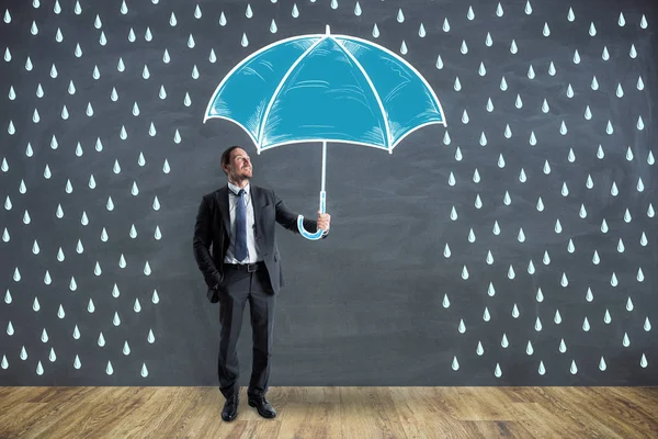 Businessman with creative drawn rain and umbrella sketch. Protection and security concept